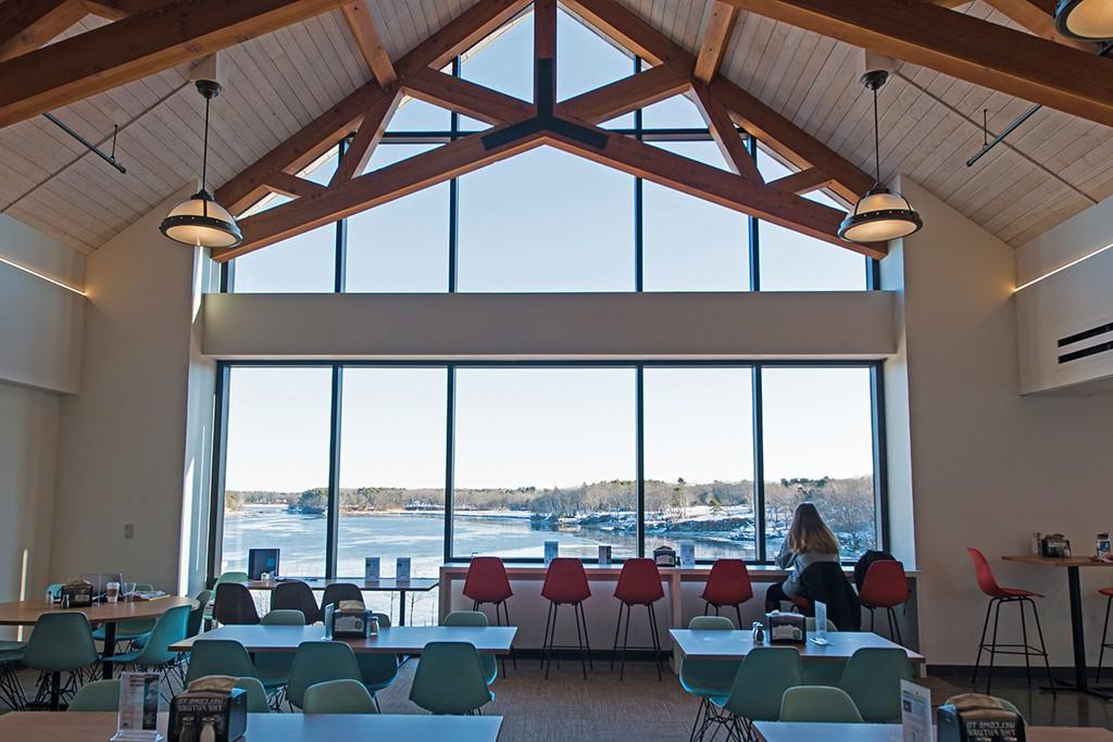 The inside of the dining hall in the Commons overlooking the Saco River