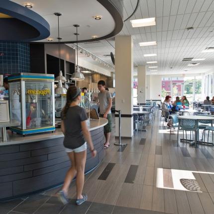 A student walks up to the bar in the Alfond Cafe