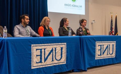 A group of interprofessional health care providers speaks to students as part of the conference